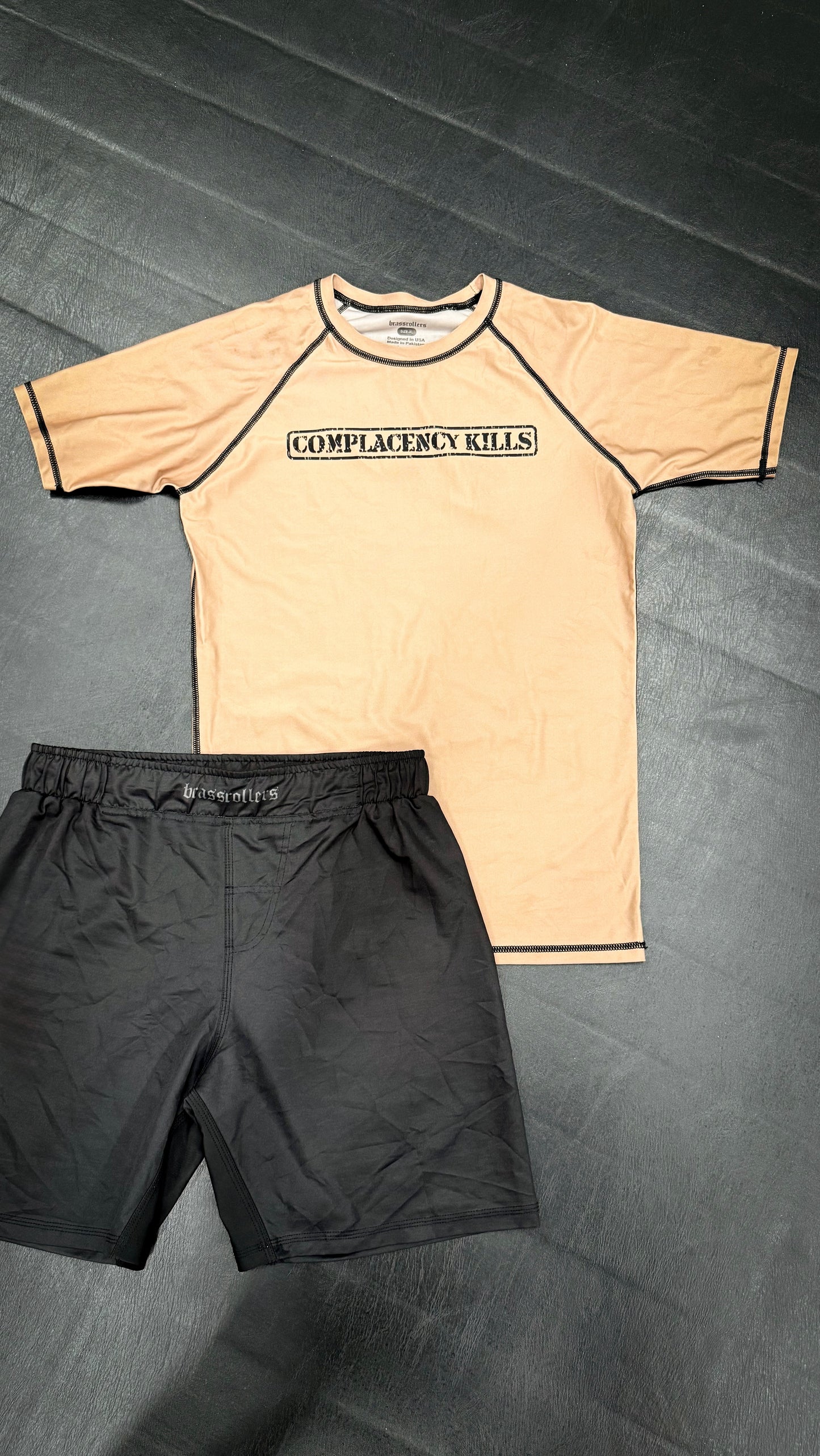 Complacency Kills Rash Guard Dark Earth