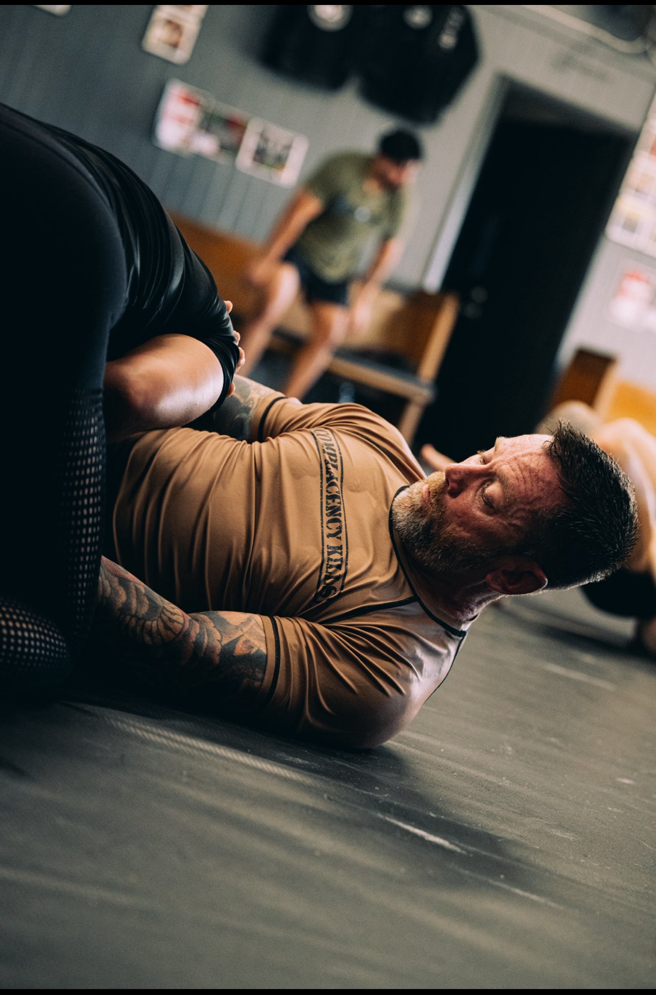 Complacency Kills Rash Guard Dark Earth